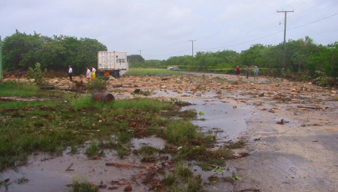 This is a side view of the road above the dock; the boulders were brought in by the violence of waves